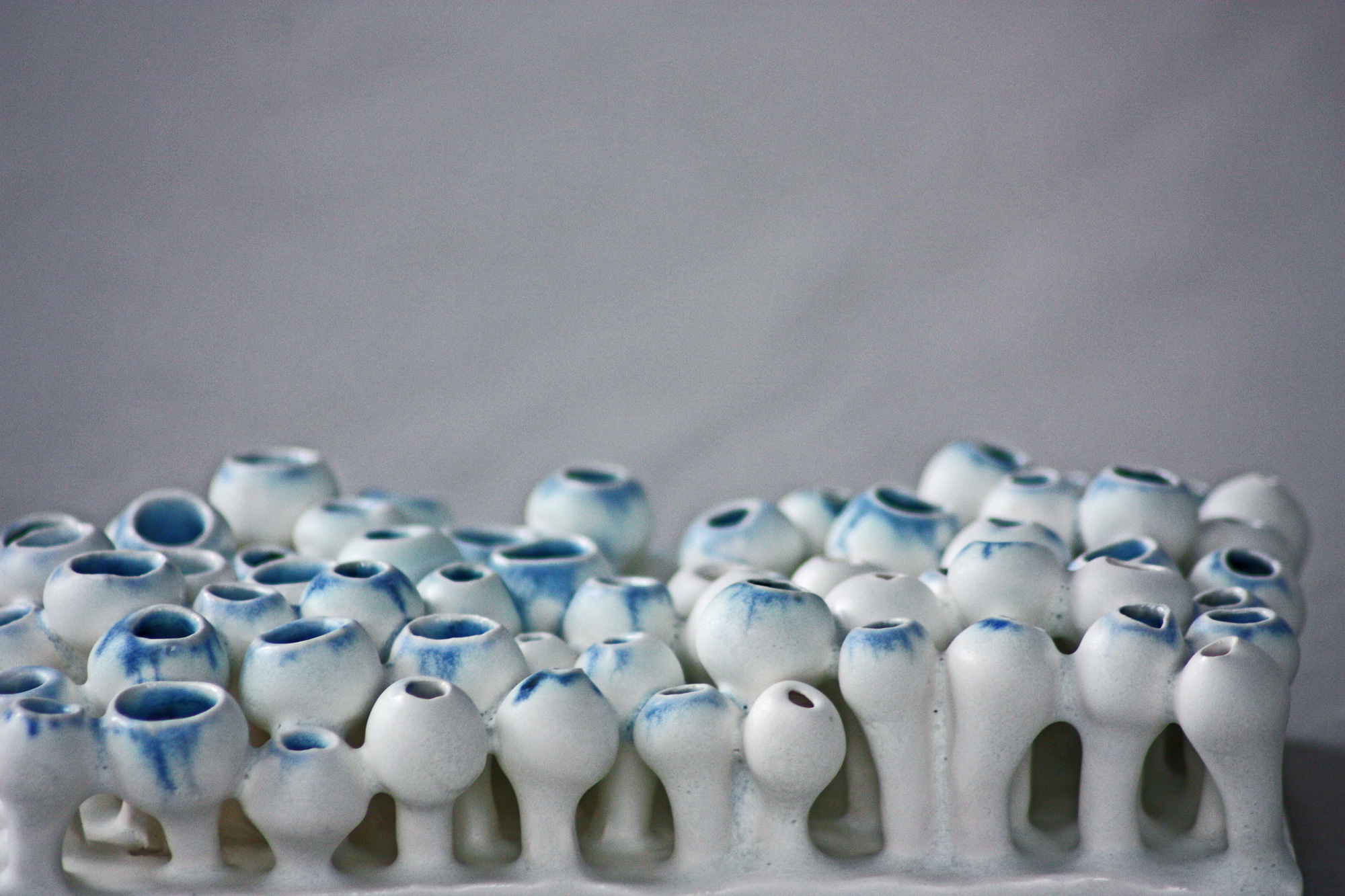 Freshly thrown ceramic forms drying on shelves