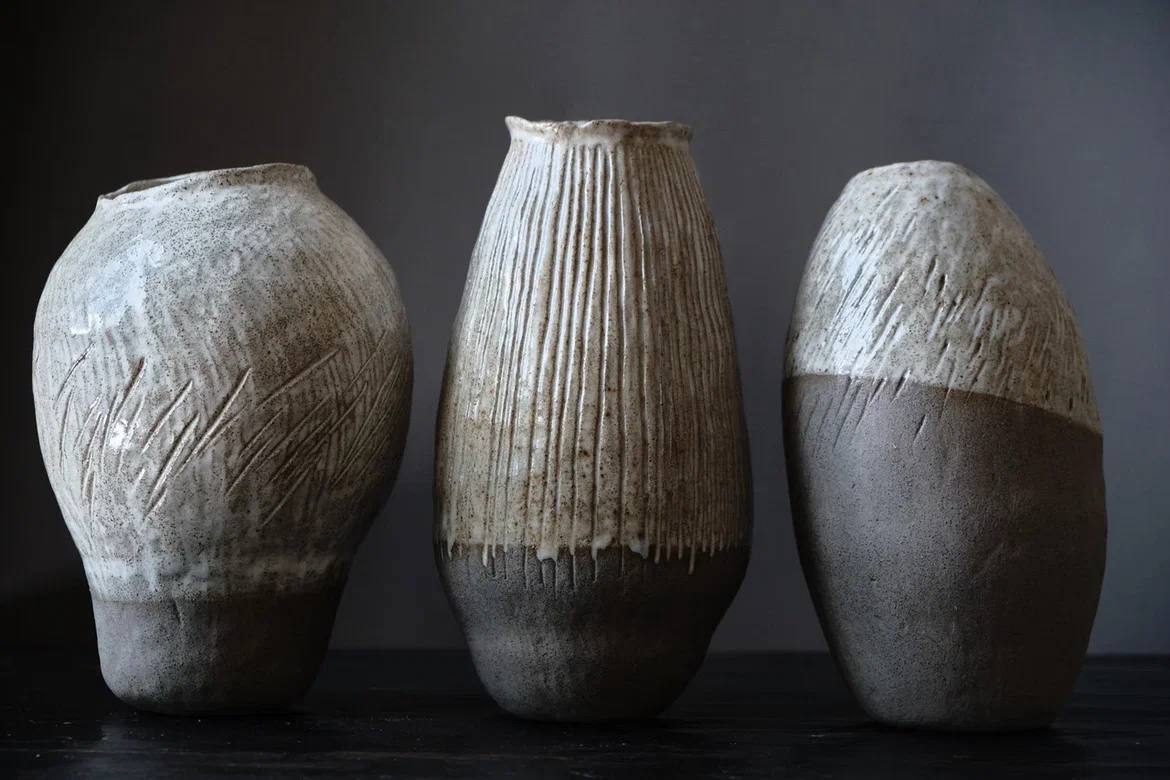 Stoneware vases with earthy glazes lined up